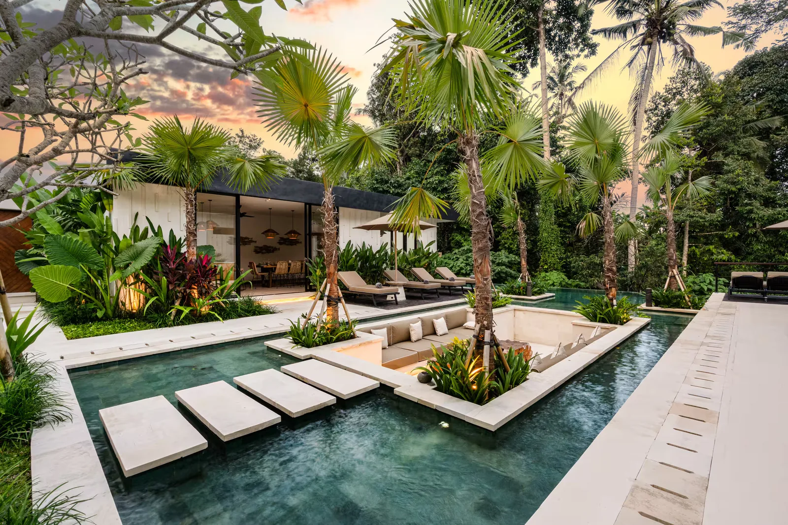 Stepping stones across the pool to the sunken lounge, at sunset